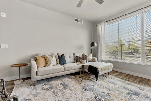 a living room with a couch and a large window